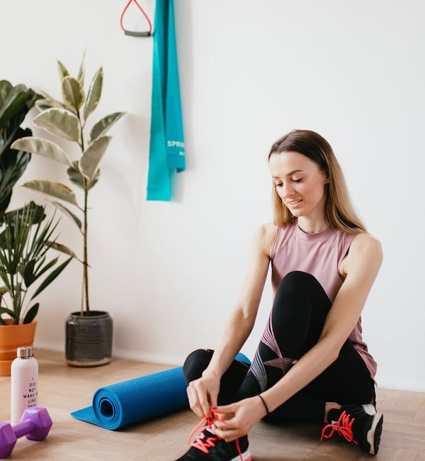 Yoga mat, water bottle, and towel neatly arranged on the floor.